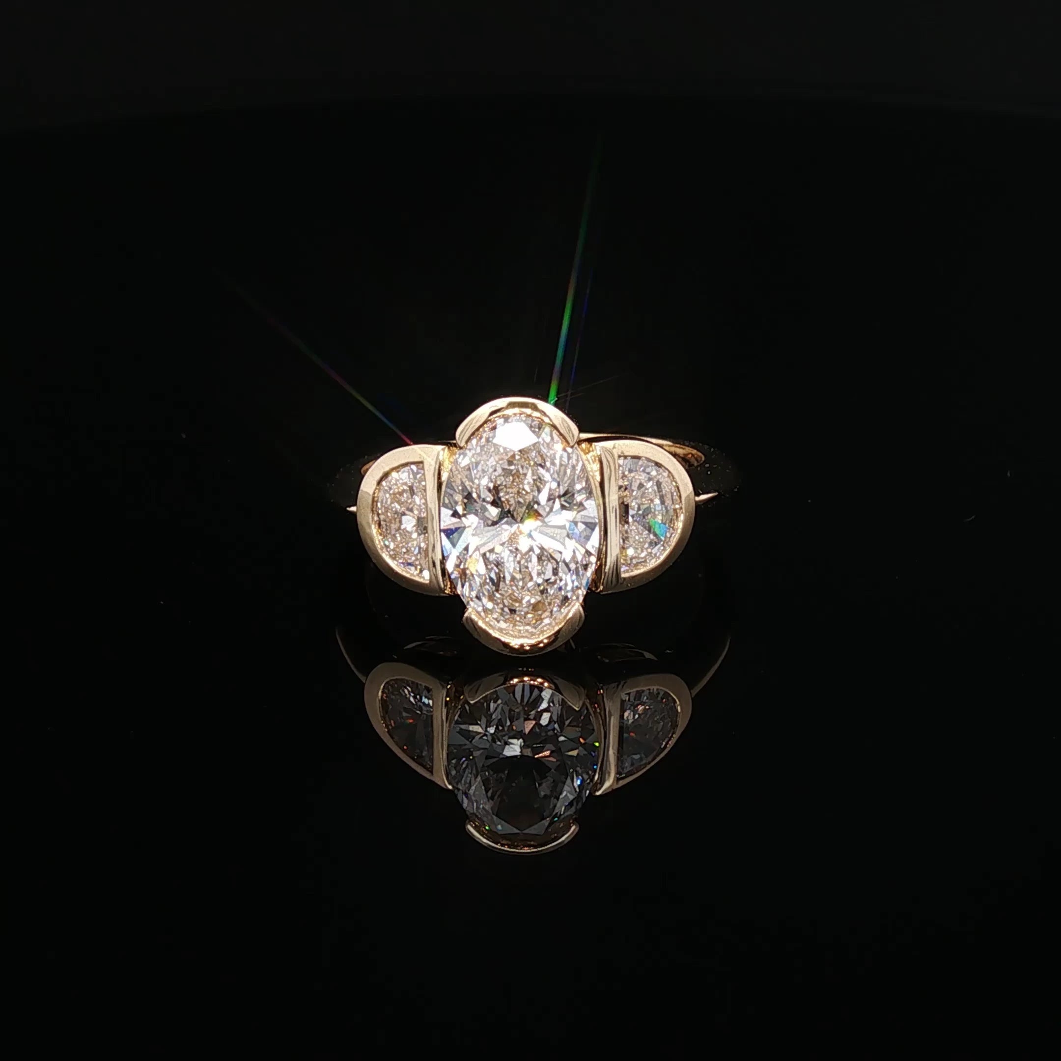 Sevilla - Oval Diamond Three-Stone Bezel Ring in Yellow Gold